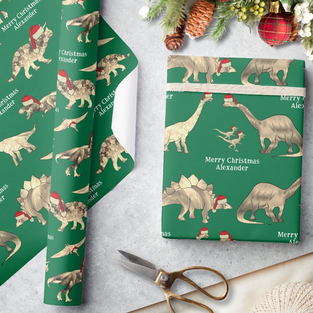 Personalised Boys Name Dinosaur Christmas Wrapping Paper (Personalized boys name merry Christmas cute dinosaurs in Santa hats green wrapping paper)