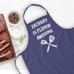 Personalised Flippin Awesome Spatula Navy Blue Apron<br><div class="desc">The perfect apron for the chef whose spatula skills are beyond compare, whether flipping burgers on the grill or pancakes on the griddle. Two crossed spatulas appear silhouetted in white under the words "Flippin' Awesome" in white capital letters on a navy blue background. Personalise it with the chef's name for...</div>