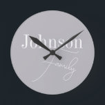 Personalised Modern Family Name Round Clock<br><div class="desc">This is a stylish, modern, grey, personalised, family name design. It is in trending grey with stylish script typography. This chic design is ideal as personalised gift or perfect as a new addition to your home decor. To personalise, simply add your name in the personalise this text box. To change...</div>