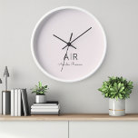 Personalised Pink Monogram Clock<br><div class="desc">Add a touch of elegance to your space with our Personalised Pastel Pink Monogram Clock. This custom timepiece features a chic pastel pink background with your chosen initial and name, making it a perfect addition to any room or a thoughtful gift for someone special. Crafted with attention to detail, this...</div>