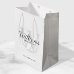 Personalised Script Groomsmen's name and Monogram Medium Gift Bag<br><div class="desc">Add a personal touch to your wedding with personalised groomsmen gift bag. This gift bag features personalised groomsman's name in grey classic script font style with wedding details in grey classic serif font style and monogram in light grey classic serif font style as background, on white background. Also perfect for...</div>