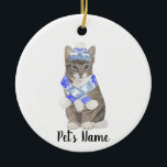 Personalised Tabby Cat (Grey) Blue Ski Hat & Scarf Ceramic Tree Decoration<br><div class="desc">Make the nice list this year with an ornament of your favourite tabby cat elf! For the sweetest gifts, pair it with a matching art print or another item from my collection for a thoughtful housewarming, cat mum, bridal shower, teacher, mother-in-law, husband, boyfriend, secret santa, sympathy, or tough-to-shop-for gift! To...</div>