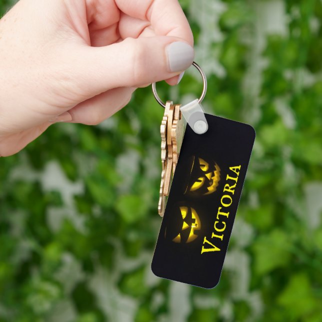 Personalised yellow on black creepy pumpkin faces key ring (Hand)