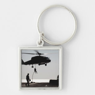 Personnel fast-rope out of an SH-60F Key Ring