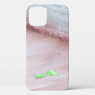 Person's foot beside green shovel on seashore iPhone 12 case