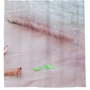 Person's foot beside green shovel on seashore shower curtain
