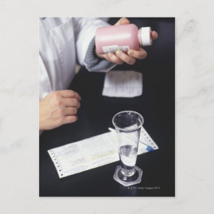 Pharmacist holding medicine bottle, close-up, postcard