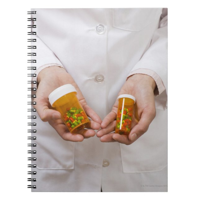Pharmacist holding pill bottles notebook (Front)