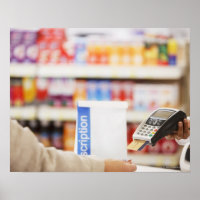 Pharmacist holding security device for customer
