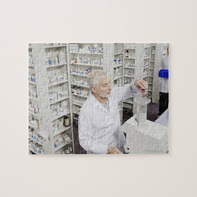 Pharmacist pouring pills into counting machine jigsaw puzzle (Horizontal)