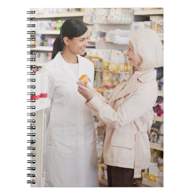 Pharmacist talking to customer in drug store notebook (Front)