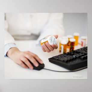 Pharmacist with pill bottles at computer poster