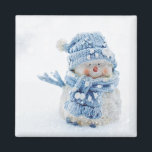 Photo of a Cute Snowman in Winter - Christmas Magnet<br><div class="desc">A magnet with a cute photograph of a little snowman. Standing outside in the winter with snow falling all around. This cute little guy is dressed up in blue knitted hat and scarf.</div>