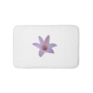 Photo of a delicate pink rain lily on a bath mat