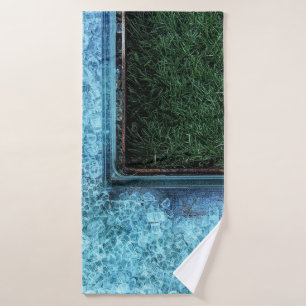 Photo of green grasses near tiles bath towel