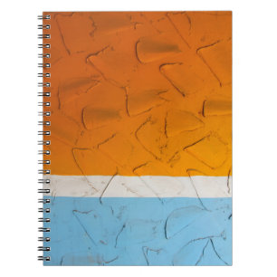 Photo of orange, white, and blue artwork notebook