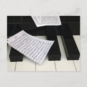 Piano keys with music postcard