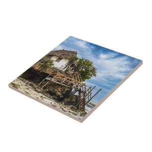 Picturesque house on a tropical coral outcrop tile