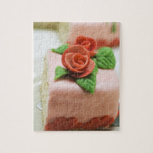 Piece of birthday cake with marzipan roses on jigsaw puzzle