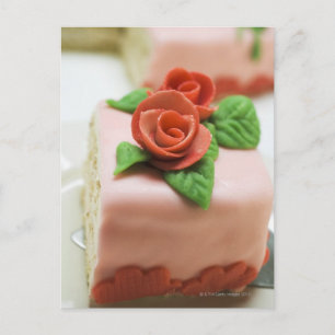 Piece of birthday cake with marzipan roses on postcard