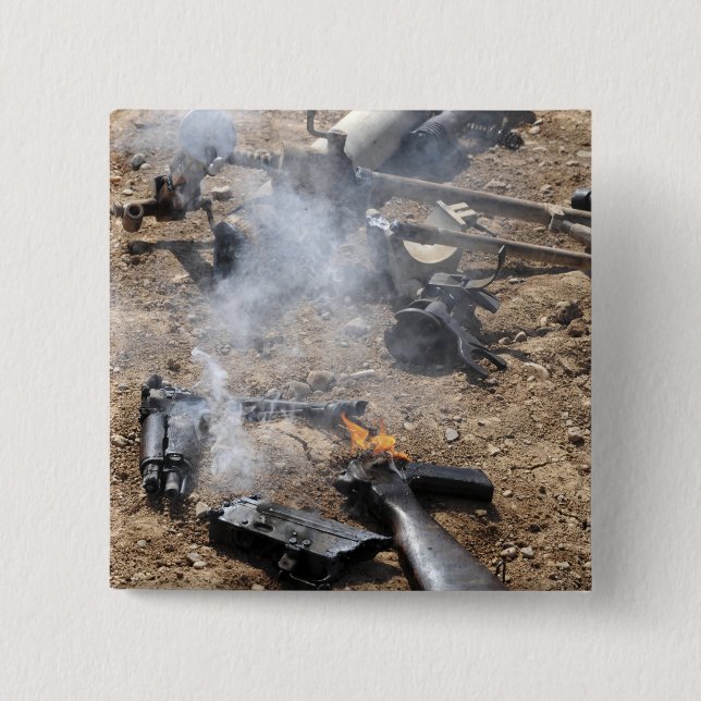 Pieces of enemy weapons lay out to cool off 15 cm square badge (Front)