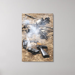 Pieces of enemy weapons lay out to cool off canvas print