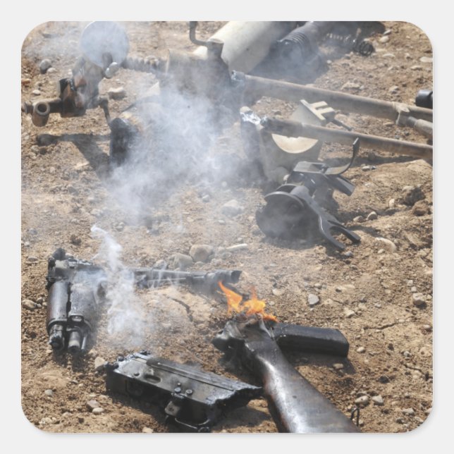 Pieces of enemy weapons lay out to cool off square sticker (Front)