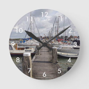Pier with boats and yachts in Marken Netherlands Round Clock