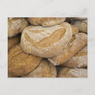 Pile of large bread loaves postcard