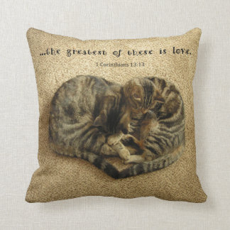 Pillow with cats in the shape of a heart.