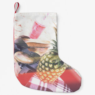 Pineapple beside phone and speaker small christmas stocking
