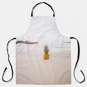 Pineapple on sand near beach apron