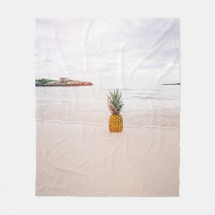 Pineapple on sand near beach fleece blanket