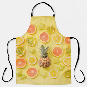 Pineapple surrounded by citrus fruits apron
