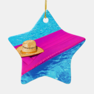 Pink air mattrass with hat in swimming pool ceramic tree decoration
