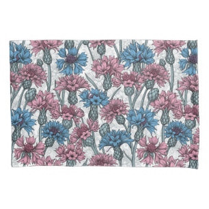 Pink and blue cornflowers on white pillowcase
