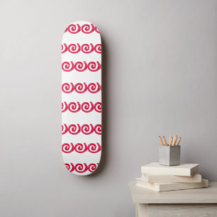 Pink and red spirals pattern on white skateboard