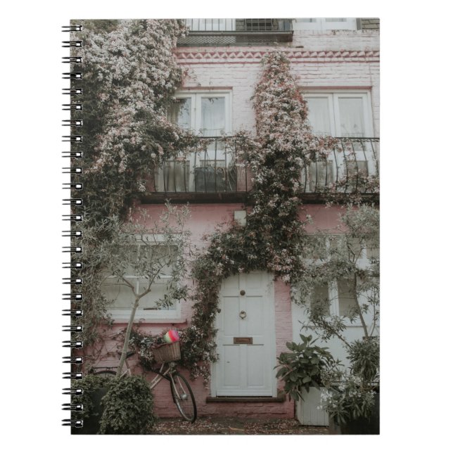 PINK AND WHITE PAINTED HOUSE COVERED WITH PLANTS A NOTEBOOK (Front)