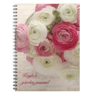pink and white ranunculus on script notebook
