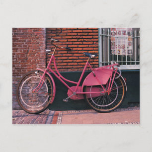 Pink Bike Against Brick Wall Postcard