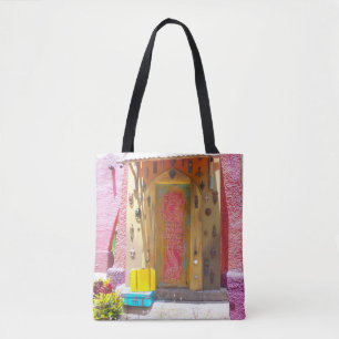 Pink building collects doorknockers on a tote bag