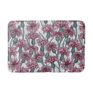Pink cornflowers, wild flowers on white bath mat