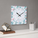 Pink flamingos tropical leaves pattern square wall clock<br><div class="desc">Tropical leaves and flowers with pink flamingos in a seamless pattern on a white background.
Customisable text. Perfect design for your tropical beach home.</div>
