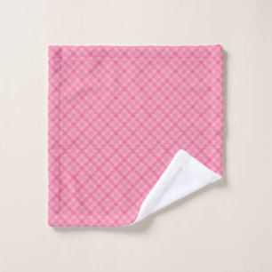 Pink plaid towel set displayed on a wall