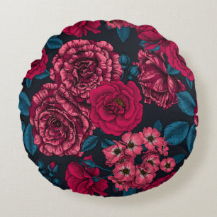 Pink, red and bi-colour roses with blue leaves on round cushion