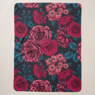 Pink, red and bi-colour roses with blue leaves on sherpa blanket