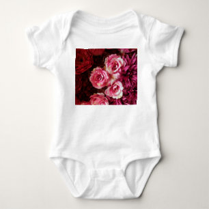 Pink, red roses: fabric background. baby bodysuit