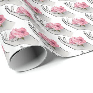 pink rose in hand wrapping paper