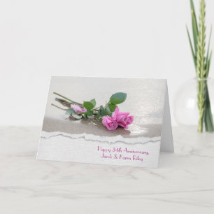 pink roses on beach for wedding anniversary card