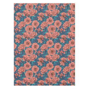 Pink roses with blue leaves on blue tablecloth